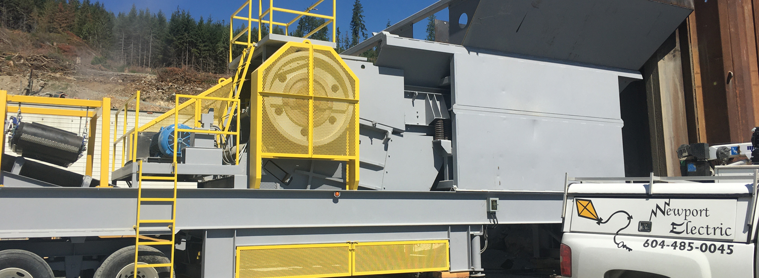 Newport Electric’s branded truck beside industrial equipment