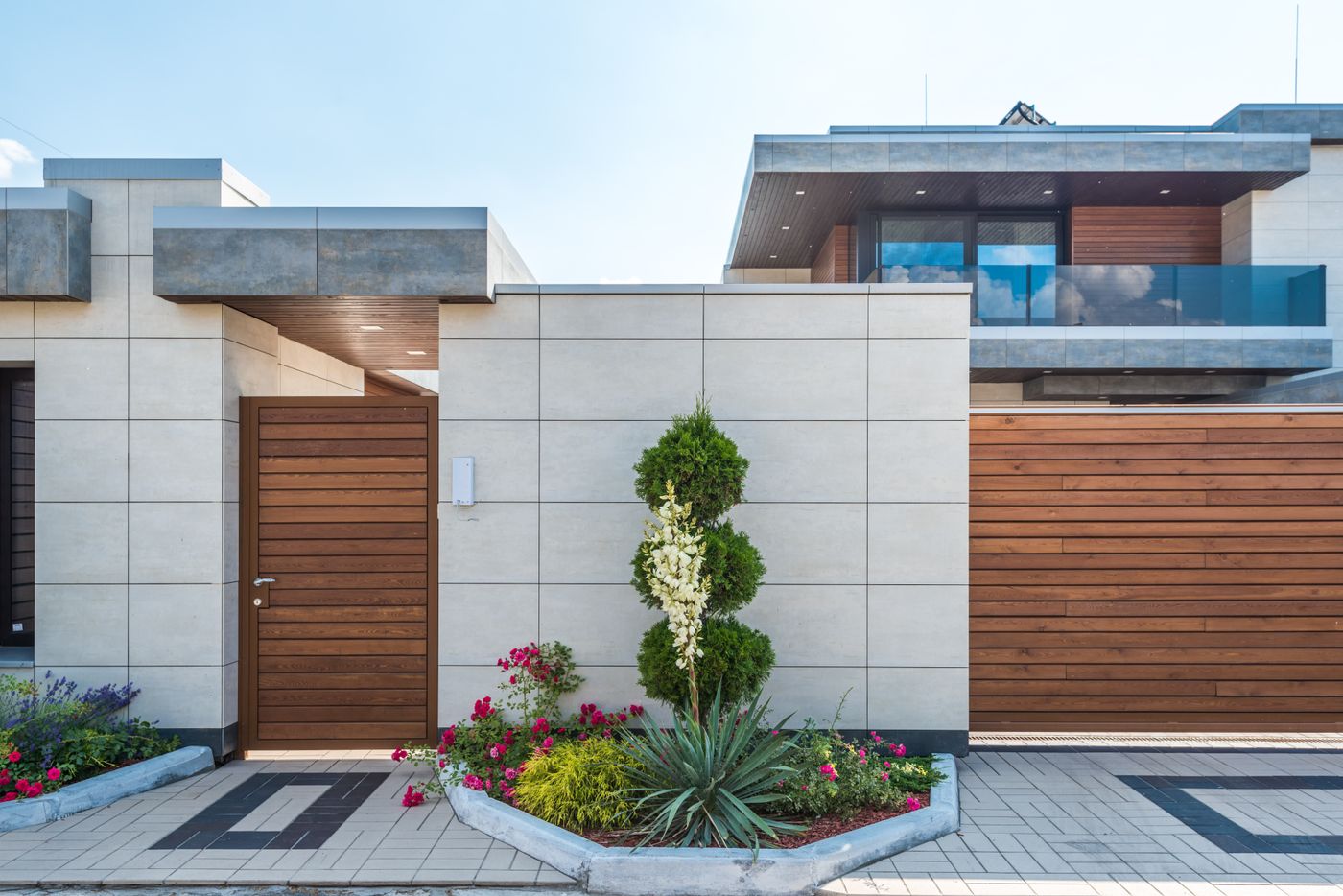 Contemporary home with wood detailing and exterior lighting
